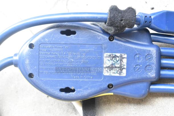 Blue relocatable power tap, Model 100579, 15A 125V, labeled for indoor use. Includes UL certification sticker.