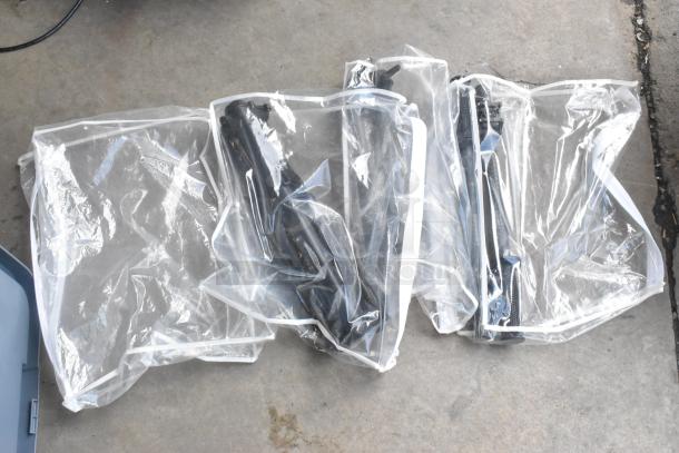 A lot of various items, including Movi handles, in plastic bags. Items appear black, packaged, and unused.
