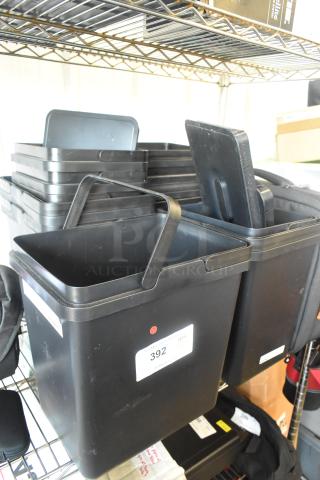 Lot of 13 black poly items on shelves, including buckets. Some items have labels with "392 QTY". Used condition.