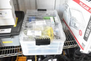 Poly bin with assorted mounting hardware, labeled "395". Includes various fasteners and brackets. Overall in used condition.