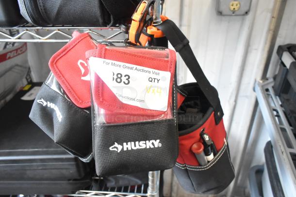 Four Husky tool bags hanging, featuring durable black and red fabric with visible logo. Includes auction tag "QTY Vx4".