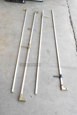 Eight metal poles with connectors, varying lengths, laid on concrete. Light wear, brass fixtures, suitable for structural use.