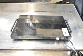 Spring ST-1220 metal induction range, 120 volts, 1 phase. Features two handles and control knob. Minor surface wear visible.