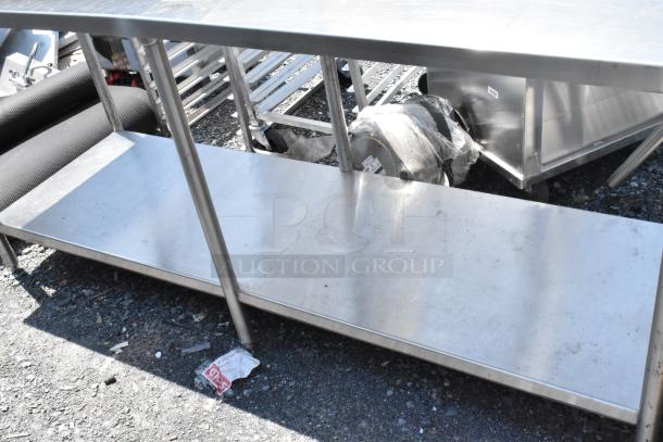 Stainless steel table with under shelf and back splash, durable and in good condition. Ideal for commercial use.