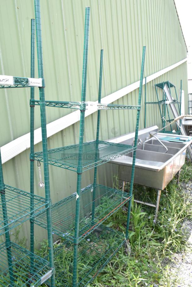 Green 4-tier wire shelving unit on commercial casters, adjustable height, outdoors, dismantling required for transport.
