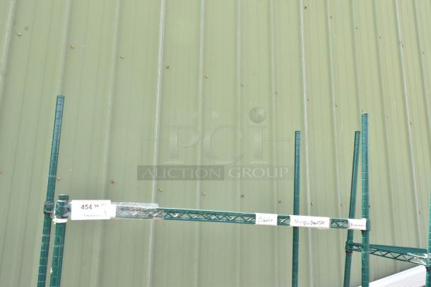 Green four-tier wire shelving unit on commercial casters, includes tags with item numbers. Buyer must dismantle.
