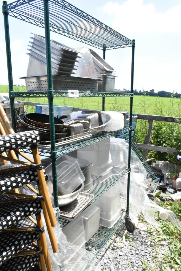 Green 4-tier wire shelving unit on casters, includes stainless steel and poly bins. Shelves filled with various containers.