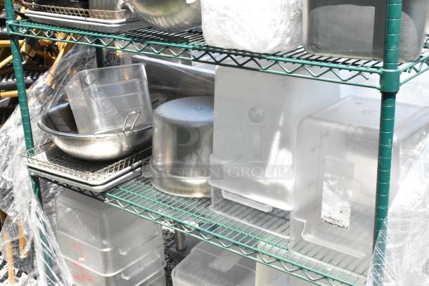Green 4-tier wire shelving on casters with stainless steel and poly bins. Buyer dismantle required; freight charges apply.