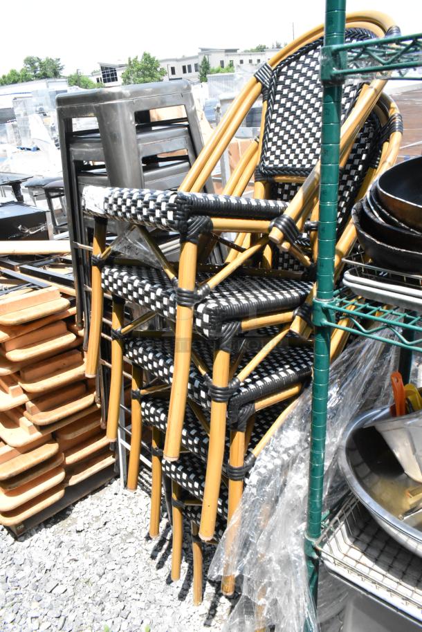 Stack of 6 brand new wicker style patio chairs, black and white pattern, some minor scratches, durable and stylish design.