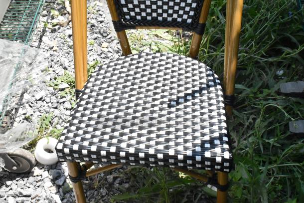 Brand new wicker style patio chair with black and white checkered pattern. Scratch and dent condition.