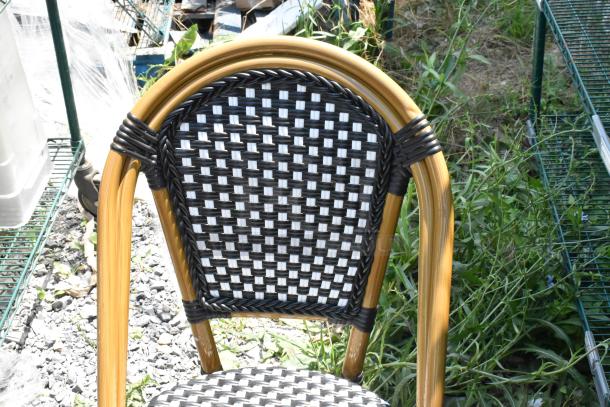 Wicker style patio chair, new with slight scratches. Black and white woven design, sturdy bamboo-like frame. Set of 6.