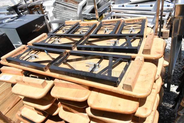Stack of folding tables with black metal frames and wooden tops, marked "Made in Germany." Good condition.