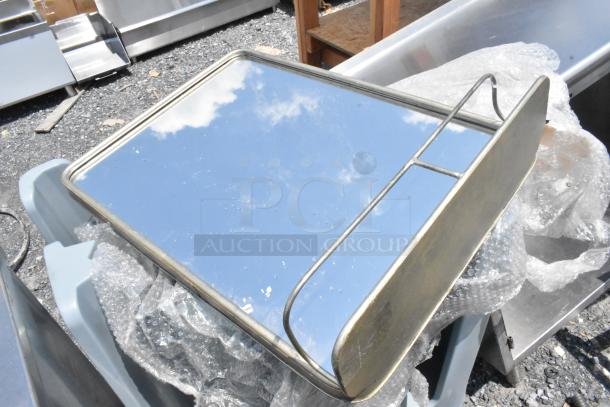 Rectangular mirror with metal frame and shelf, reflecting blue sky. Slight wear visible; packaged with bubble wrap.