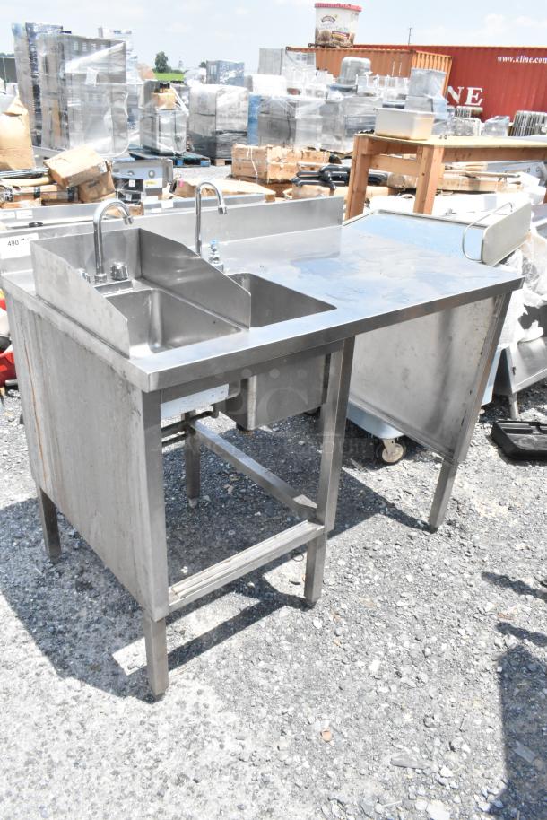 Stainless steel table with two single sink bays, faucets, and handles, in good condition, ideal for commercial use.