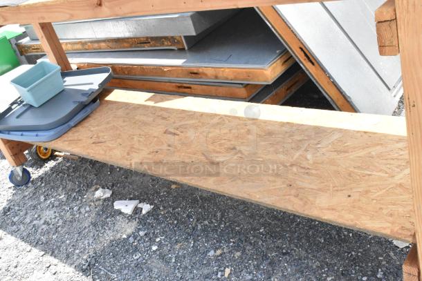 Wooden table with under shelf, on commercial casters. Features sturdy construction, ideal for workshop or garage use.