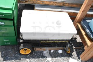 Rock N Roller Multi Cart with casters, black frame, yellow wheels, white storage box on top, in used condition.