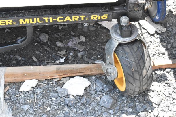Rock N Roller Multi Cart R16, shown with durable caster wheel on rocky ground; well-maintained condition.