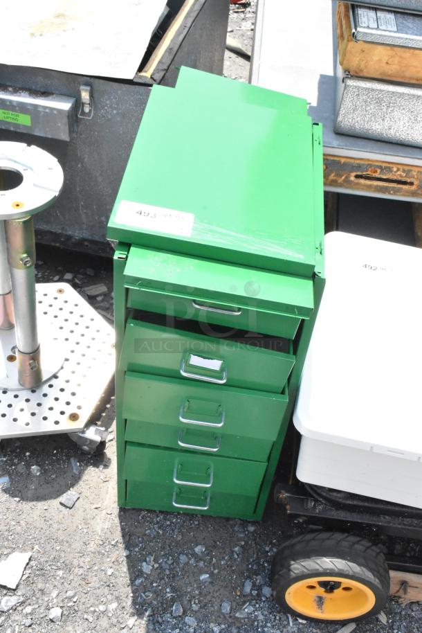 Green metal filing cabinet with five drawers, labeled "493," slight surface scratches, sturdy handles, and visible in outdoor setting.