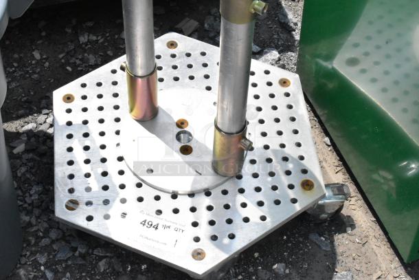 Hexagonal metal unit on commercial casters with perforated surface. Features two vertical poles and auction label "494."