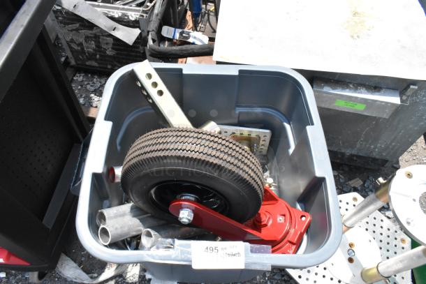 Blue poly trash can filled with various metal parts, including a wheel and red metal bracket. Label indicates contents.