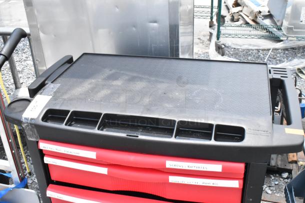 Black and red poly cart on commercial casters, with labeled drawers and compartments; durable design for storage.
