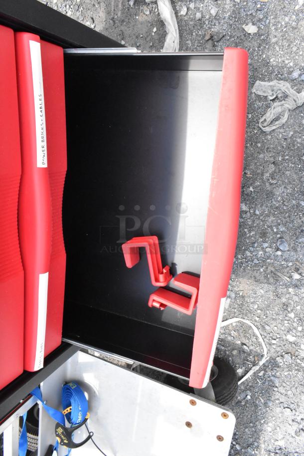 Black and red poly cart on commercial casters, includes labeled compartments for organizing power bricks and cables.