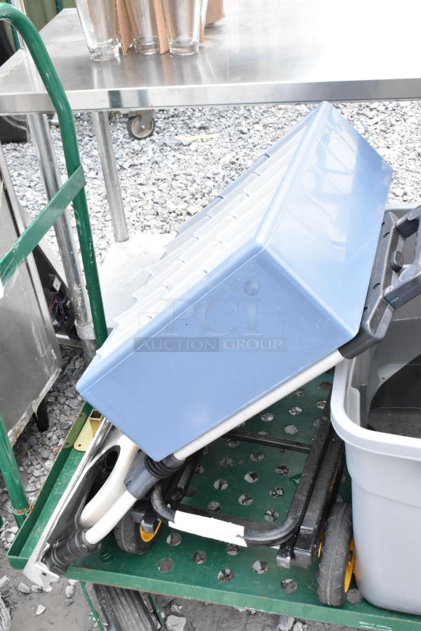 Green metal flat cart with sturdy handles. Includes folding table and blue poly bin. Appears in used but good condition.
