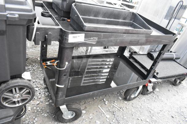 Black poly 2-tier cart on casters with storage trays, item tag "502". Features durable design, used condition.