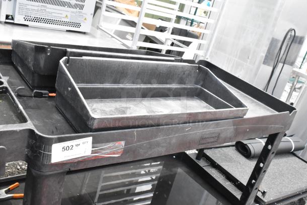 Black Poly 2-Tier Cart on casters, used condition. Features two sturdy tiers and easy mobility. Marked "502" for auction.