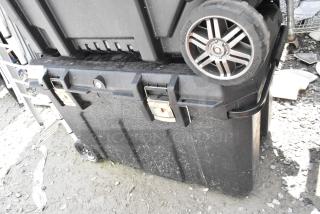 Stanley black poly case on casters, robust design, dual locks, visible wear, ideal for secure storage and transport.
