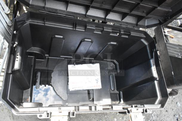 Stanley black poly case on casters, open lid showing spacious interior. Ideal for transport and storage. Very good condition.