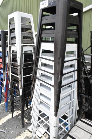 10 Tolix style metal bar height stools in assorted colors; stackable design, industrial look, good condition.