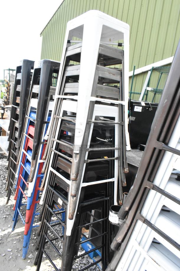 Stack of 10 metal Tolix style bar height stools in assorted colors, showing minor wear. Durable and ideal for bar settings.