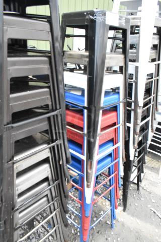 Stacked metal Tolix style bar stools in various colors, bar height, auction item of 10 stools, good condition.