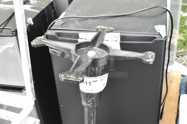 Black metal table base with a cross-shaped top, visible wear. Auction tag on base displays number. Suitable for custom tabletop.