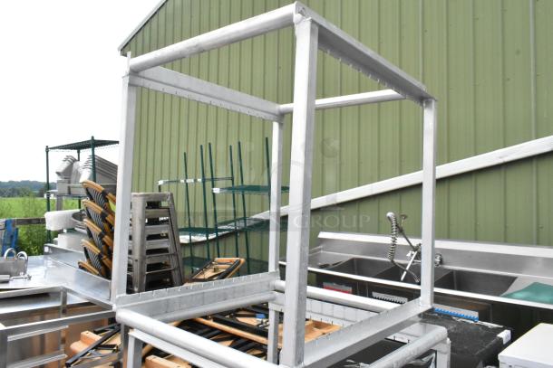 Three-tier metal pan rack frame in good condition, featuring sturdy construction for kitchen use, ideal for efficient storage.