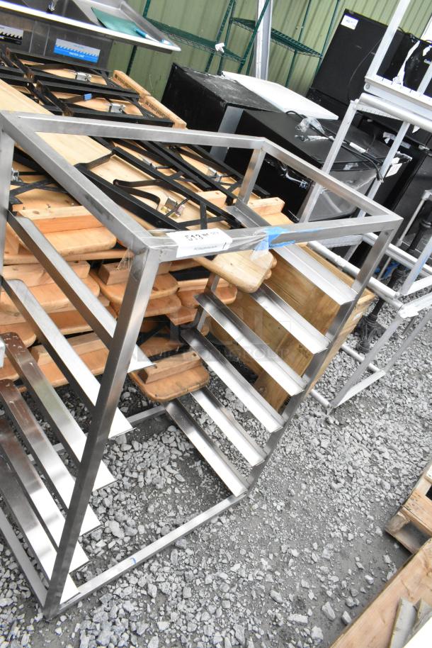 Metal pan rack with multiple shelves, silver finish. Suitable for kitchen or storage. Appears in good condition.