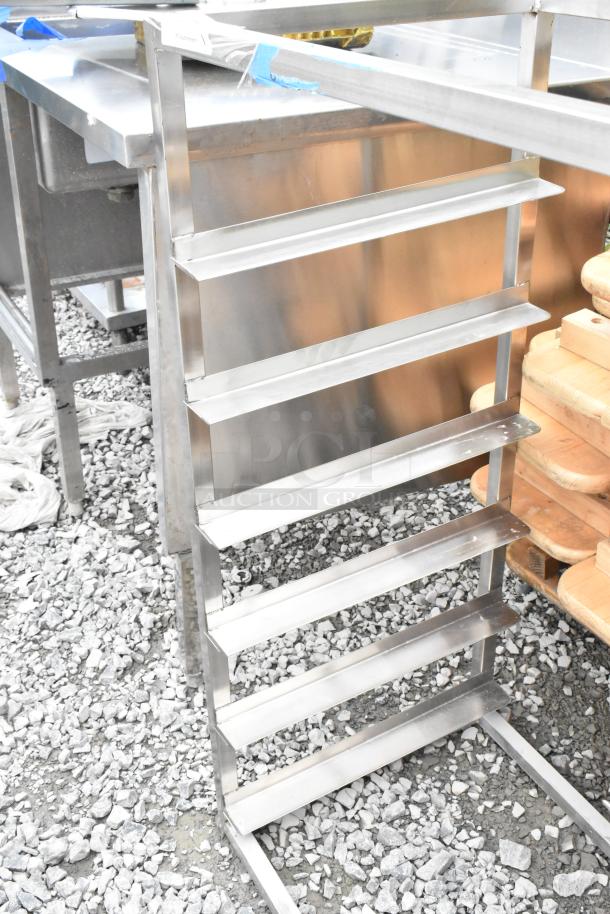 Stainless steel pan rack with eight shelves, in excellent condition; ideal for industrial kitchen use.