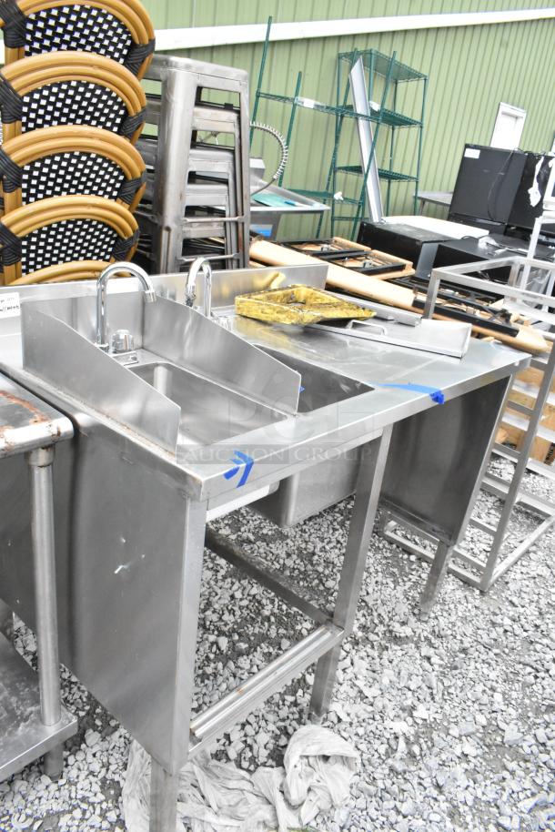 Stainless steel table with two single sink bays and dual faucets, in used condition, perfect for commercial kitchens.