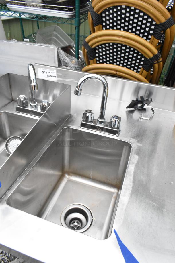 Stainless steel table with two single sink bays and faucets, includes metal tags indicating quantity details.