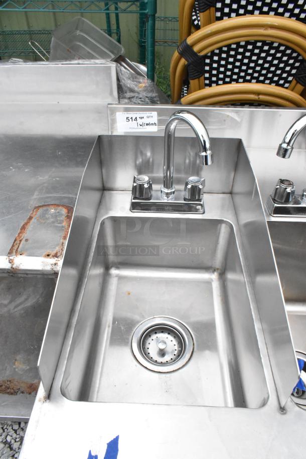 Stainless steel table with two single sink bays, chrome faucets, minor surface rust, shown with auction tag number 514.