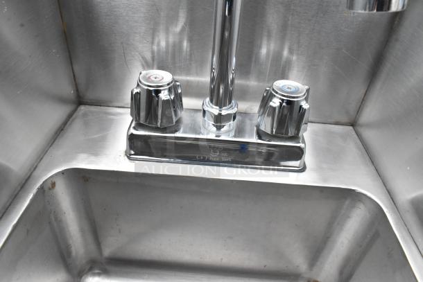 Stainless steel table with two single sink bays and dual faucets. L & J New York brand. Slight signs of wear.