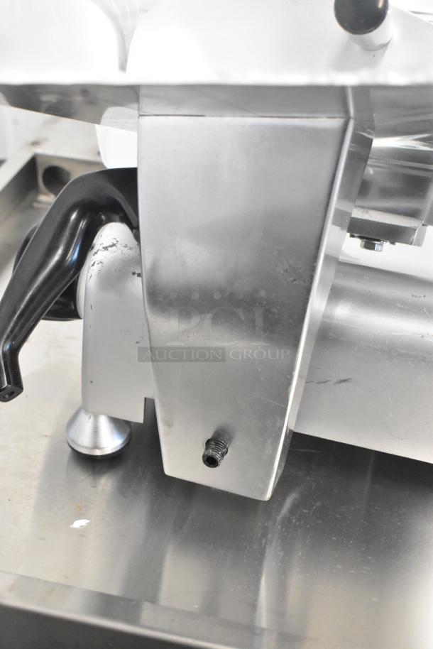 Avantco 177SL312 metal countertop meat slicer. Includes blade sharpener. Visible wear on metal surface. 115V, 1 phase.