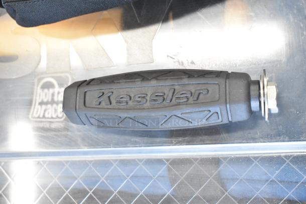 Rubber Kessler handle with textured grip and metal attachment, on a reflective surface with Porta-Brace logo visible.
