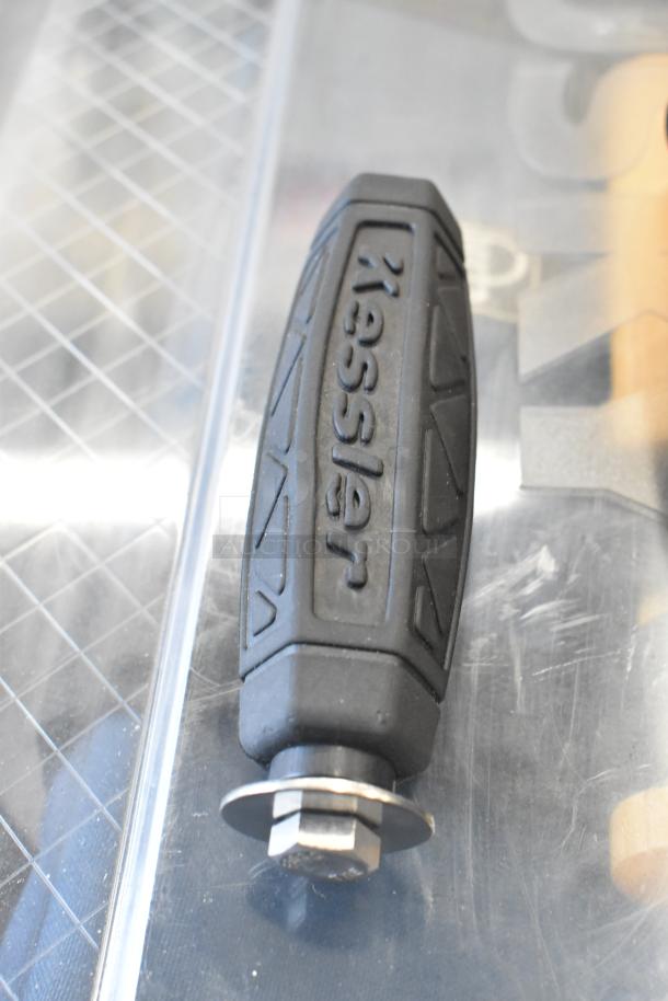 Black Kessler handle in poly bin, part of mixed auction lot, shows logo and grip texture, in good condition.