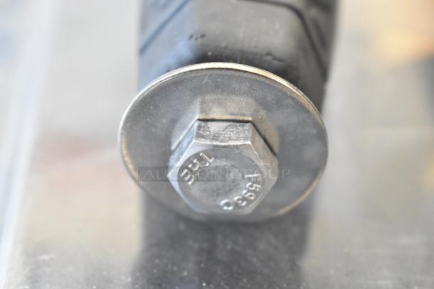 Bolt with washer marked "F599" on metal surface, part of a lot including a Movi Elevator in poly bin.