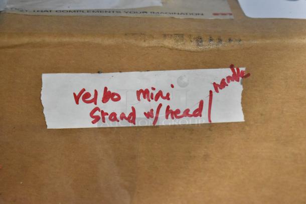 Velbo Mini Stand with Head in original packaging, handwritten label indicating item name. Auction item, condition not visible.