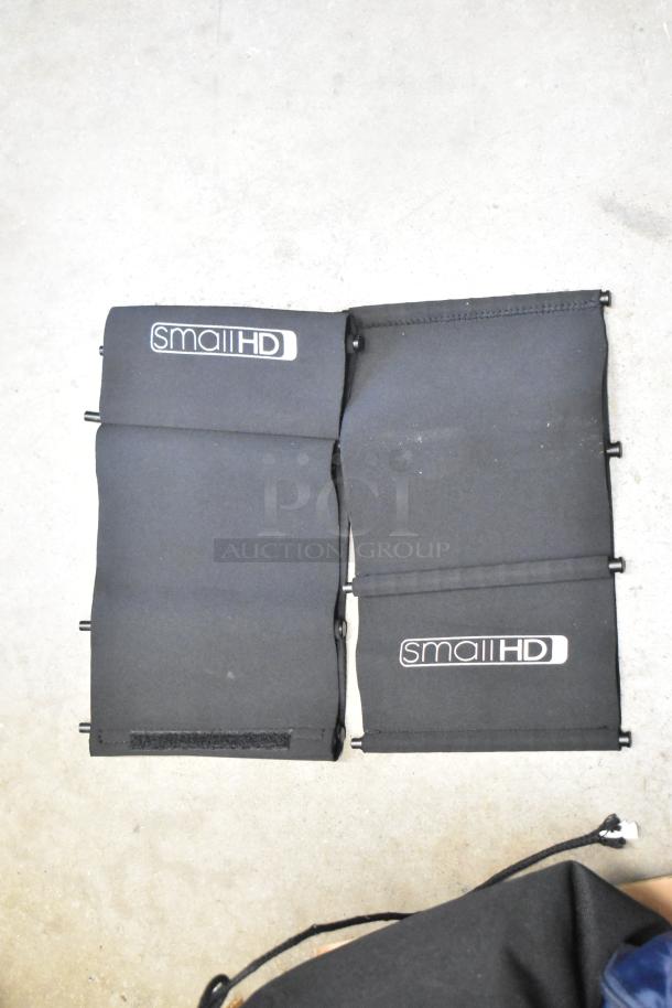 Three black SmallHD bags with adjustable straps, featuring the brand logo. Bags include additional contents. Condition appears good.