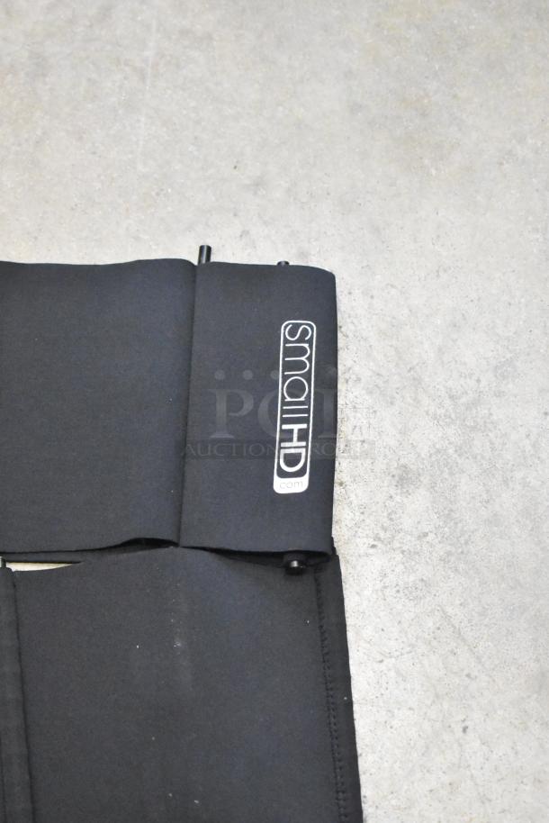 Black SmallHD bag with visible branding, part of a lot of three bags with contents, good condition.