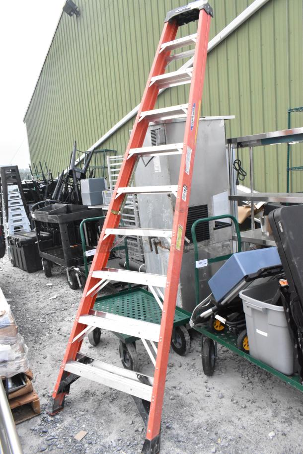 Werner 10' A-frame ladder in used condition, orange, with visible labels. Suitable for various tasks, sturdy build.